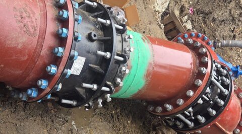 Close-up view of bespoke ductile iron pipework and flanged fittings on site following installation onto the water network
