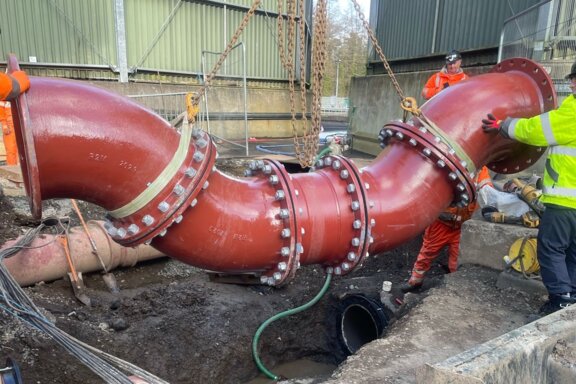 Bespoke Ductile Iron Fittings Bespoke ductile iron pipeline being lifted by chains into position by engineers ahead of installation on site