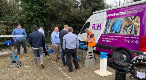 R2M roadshow van set up on site, with a technical expert leading discussions with customers about pipeline products and solutions