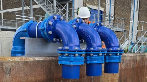 On-site System 2000 installation, showing a man fitting flange adaptors onto a new water network as part of a major pipeline project
