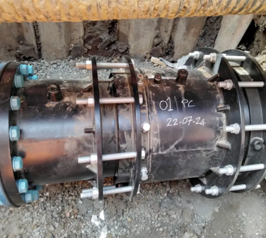 Exposed cast iron water main in an excavated trench, showing the condition of the existing pipeline prior to rehabilitation