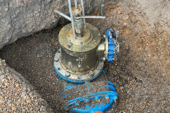 Line stop installation in an excavated trench showing a isolation valve and equipment fitted