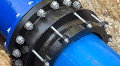 Close-up of flange adaptor connecting blue Molecor MoPVC pipes