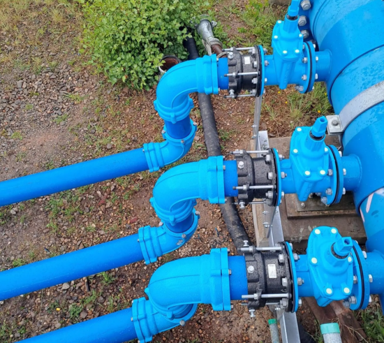 Installed System 2000 bend fittings on multiple pipelines connected to valves and couplings