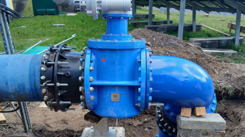 Close-up of newly installed ductile iron fittings, bends and valve assembly including end-restraint couplings