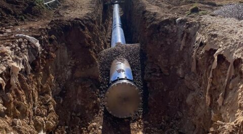 Different section of a newly installed pipeline in an open excavation, featuring Nova Siria fittings and a blank flange at the pipe end