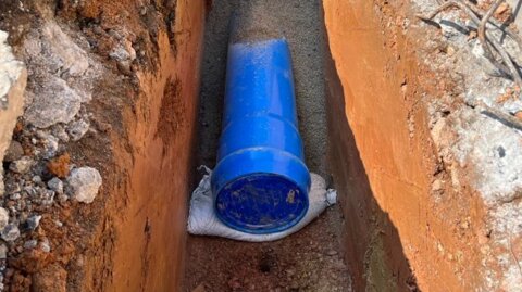 Close-up view of Molecor MoPVC pipe bedding within a narrow trench and ready for backfilling